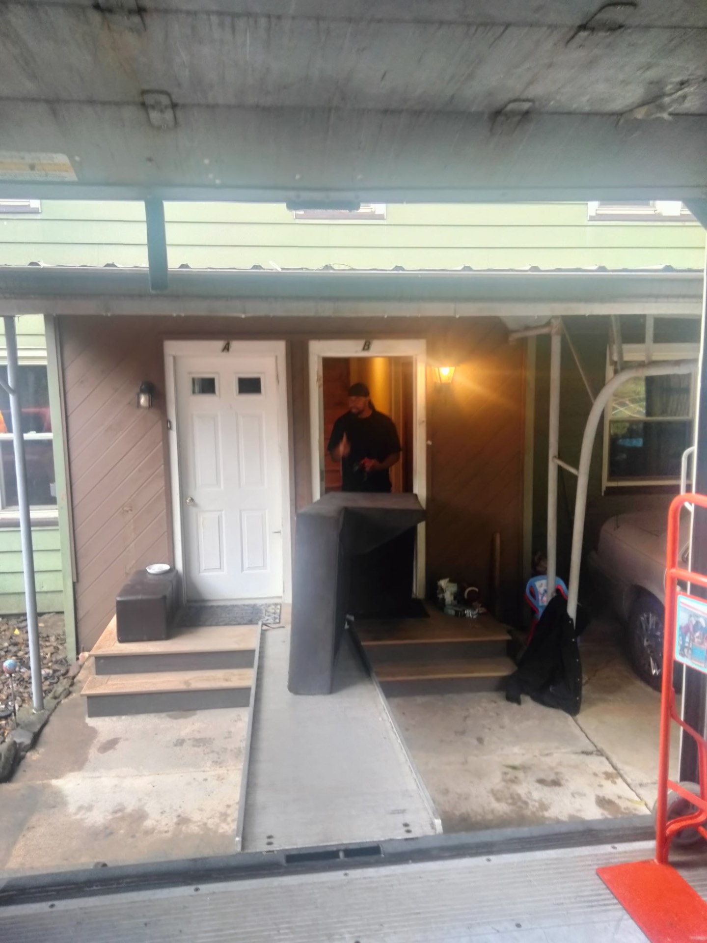 Majestic Mover crew member at the door beside a sectional sofa ready to load