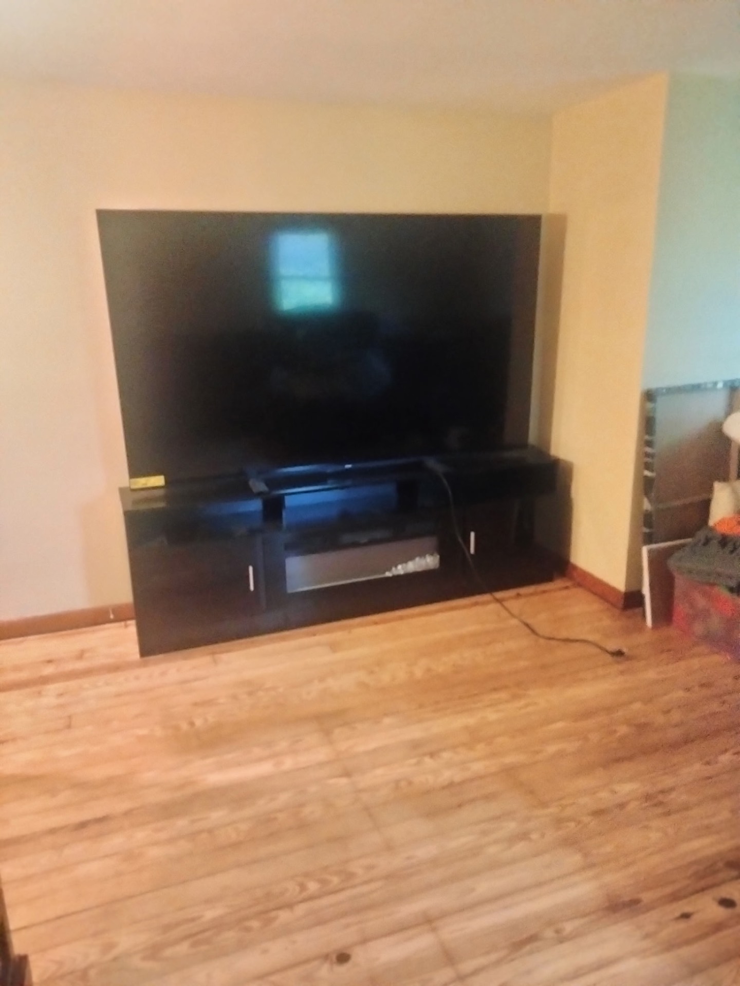 Large TV and entertainment stand set in place in the new living room